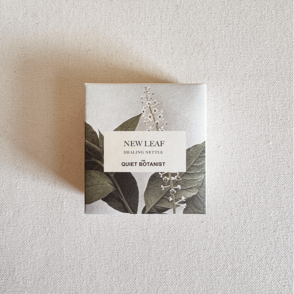 The Quiet Botanist Product packaging with 'New Leaf' branding on a textured beige background